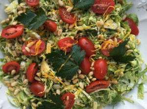 Organic Brussel Sprout Salad with Toasted Pine Nuts Meyer Lemon and Grape Tomatoes